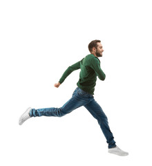 Young man in casual clothes running on white background