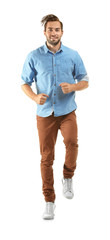 Young man in casual clothes running on white background
