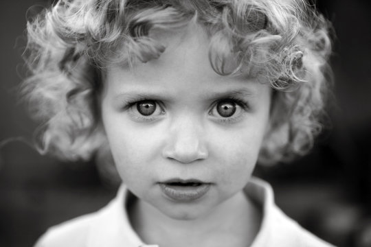 Intense Portrait Of Blonde Curly Haired Toddler