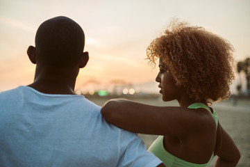 Young attractive black couple at the beach at sunset