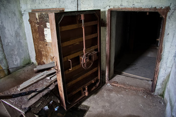 Rusty heavy steel hermetic door of the abandoned Soviet bomb shelter