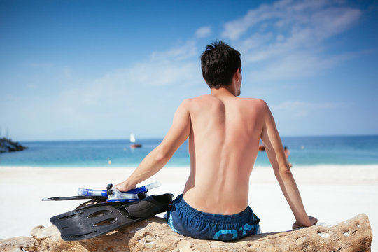 Man watching  the Water Holding Fins and Diving Mask
