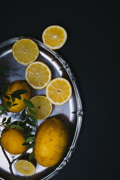 Sliced lemons on a silver tray.