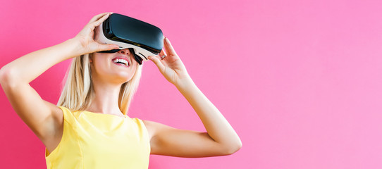 Happy young woman using a virtual reality headset
