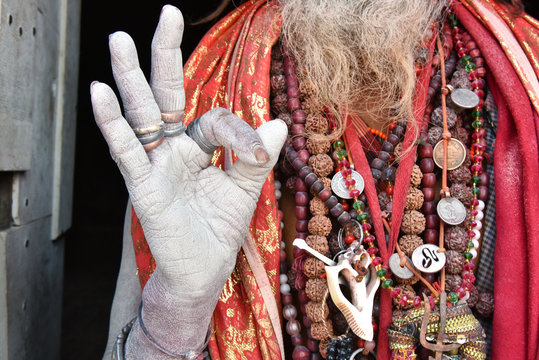 Detail of a sadhu's hand praying on a temple