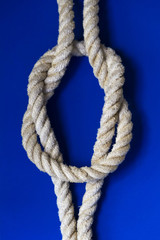 Square knot / Reef knot on the blue background.
