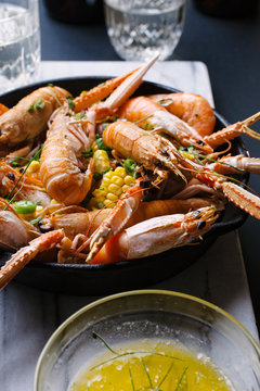 Shrimp and corn served in a skillet with garlic butter.
