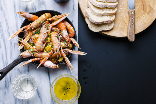 Roasted langoustines and shrimps on a bed of smoked garlic with corn.