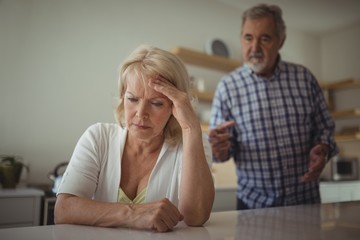 Senior couple arguing in kitchen