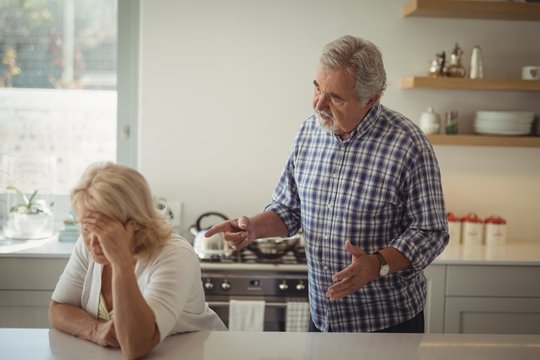 Senior couple arguing in kitchen