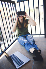 Beautiful young woman enjoying virtual reality at her home.