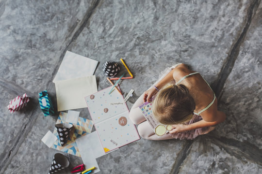 Cute Blonde Girl Drawing at Home