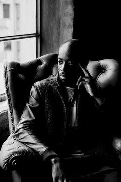 African American man's portrait in an armchair