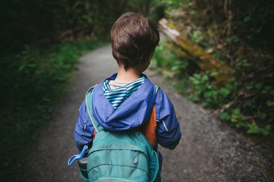Young caucasian boy on walking trail at nature preschool