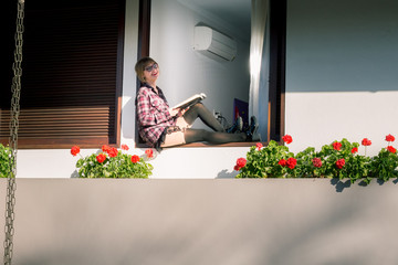 Woman sitting by her window