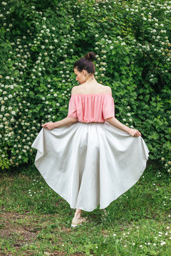 Portrait of a female model in beautiful skirt from back