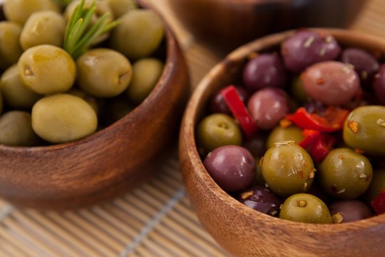 Close up of olives in wooden container