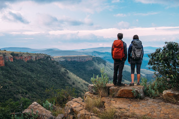 Hikers on a mountain summit enjoying the view of a scenic valley
