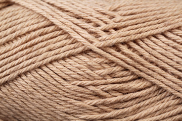 A super close up image of brown yarn