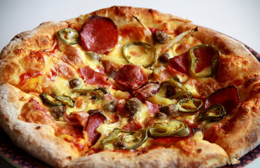 Pizza with topping Smoked Beef, Onion, Green Pepper, and Mozzarella Cheese.