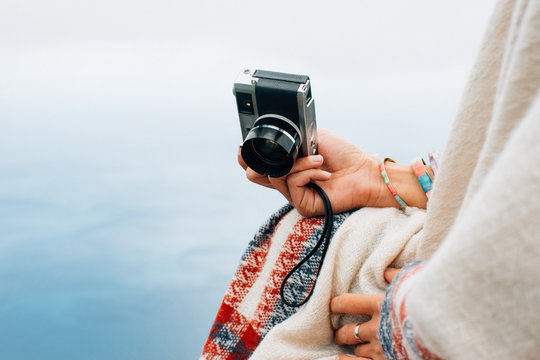 Woman holding old fashioned rangefinder camera
