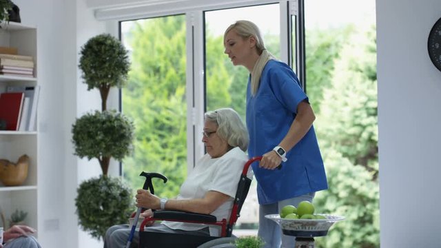 Senior people elderly in a care home looked after by nursing staff