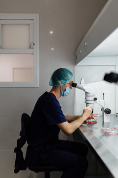 Young Biologist Using a Microscope in the Laboratory