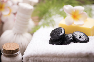 Spa stones with towel and plumeria