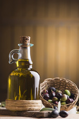 Olive oil and olives on wooden rustic table