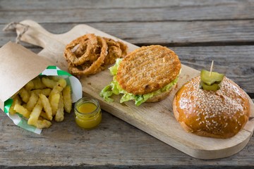 High angle view of burger with onion rings and french fries