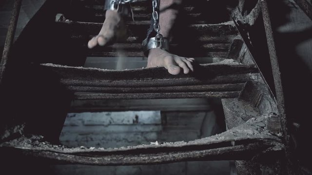 prisoner in chains down the stairs