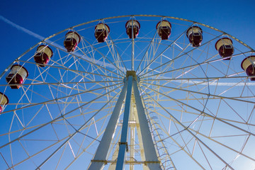 Ferris wheel against the blue sky.