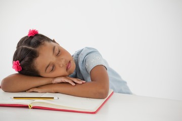 Young girl sleeping with her head on desk