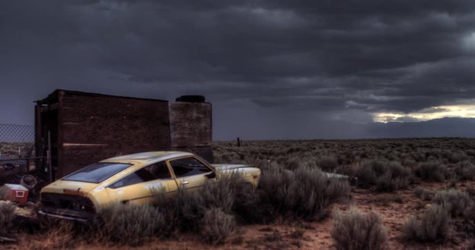 Rain Storm Over the New Mexico Desert Plain with Old Car in Foreground