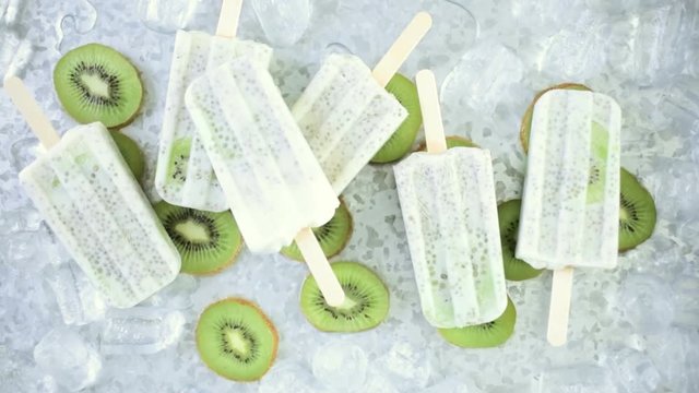 Kiwi coconut chia popsicles with fresh kiwi and ice in metal tray