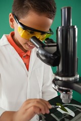 Schoolboy using microscope