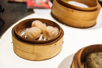 Har Gow: Steamed thin flour sheet wrap with shrimp in bamboo basket at the restaurant in Dubai.