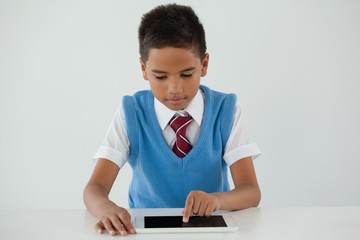 Schoolboy using digital tablet