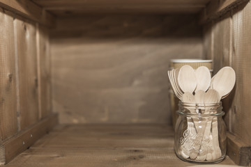 Wooden spoons on a glass inside a wooden box