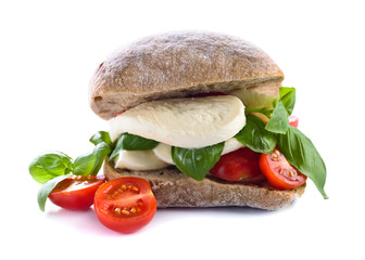 Ciabatta with mozzarella, tomato and basil isolated on white