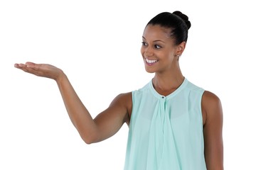 Businesswoman making hand gesture while presenting