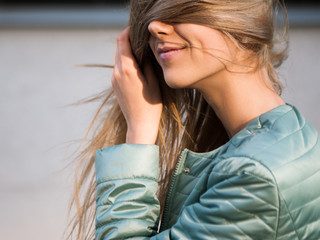 Unrecognizable girl covering face with hair. Happy woman hiding from world, modest and shy female....