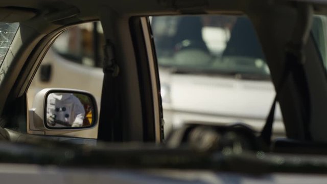  Aggressive astronaut with road rage vandalizing car mirror with baseball bat