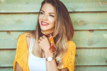 Fashion woman is wearing sweater over wooden background