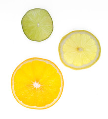 three cut slices of citrus on white isolated background