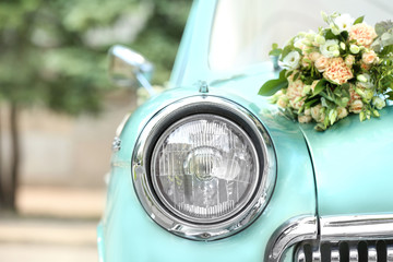 Beautiful floral decoration on wedding car outdoors