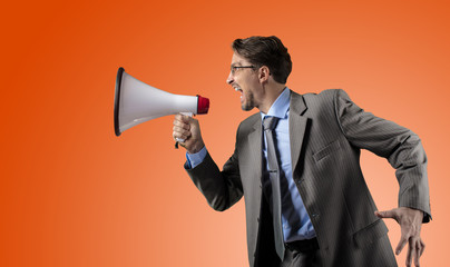 Businessman in gray suit with megaphone