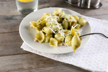 Fork with pasta on blurred background