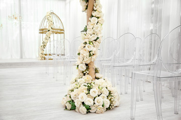 Tree decorated with beautiful flowers in wedding hall