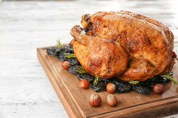 Roasted turkey with prune and nuts on wooden board